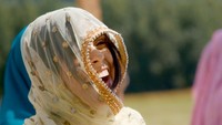 wedding guest laughing during joyful sikh ceremony