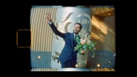 groom flashing peace sign while captured on super 8mm film