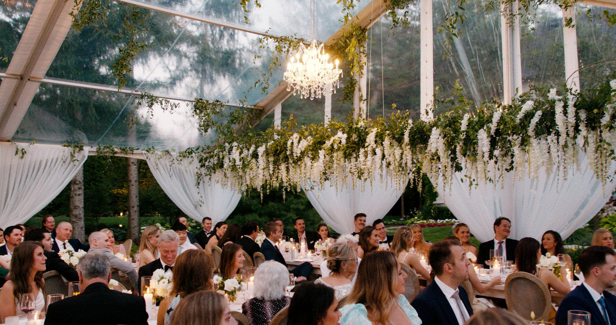 tented wedding reception with beautiful floral installation