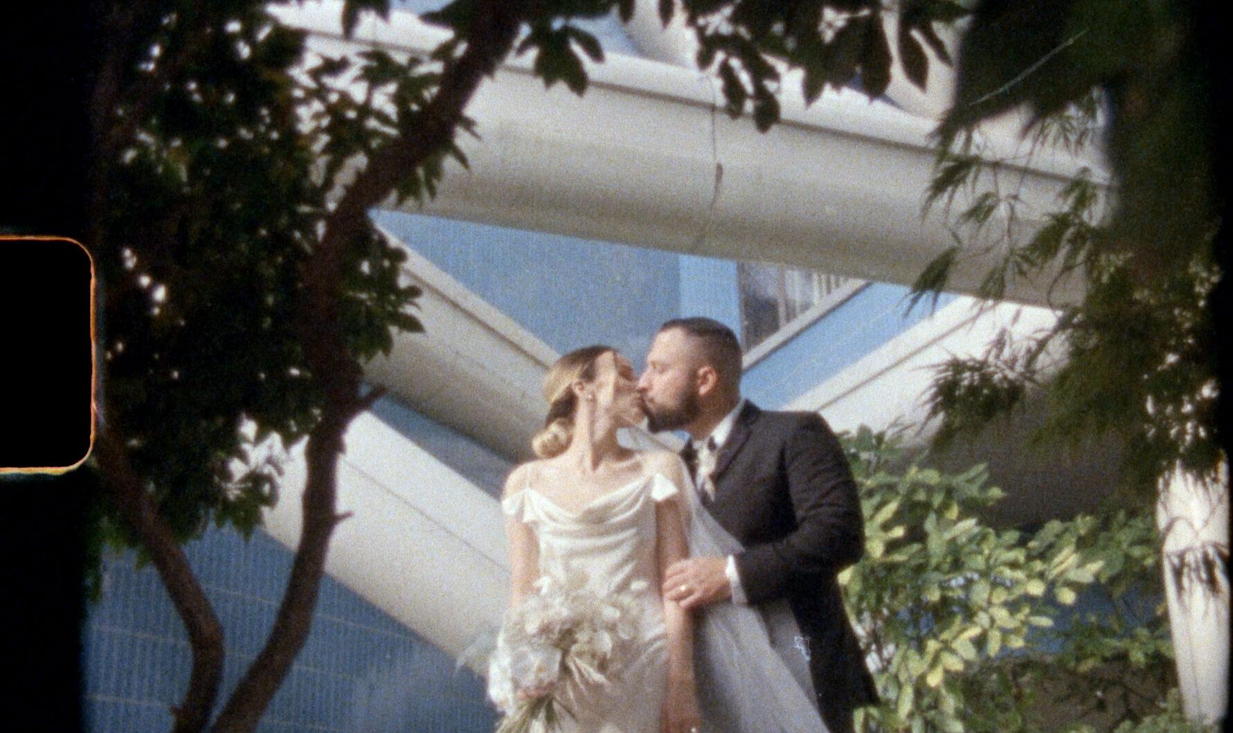 super 8mm film still of wedding couple kissing
