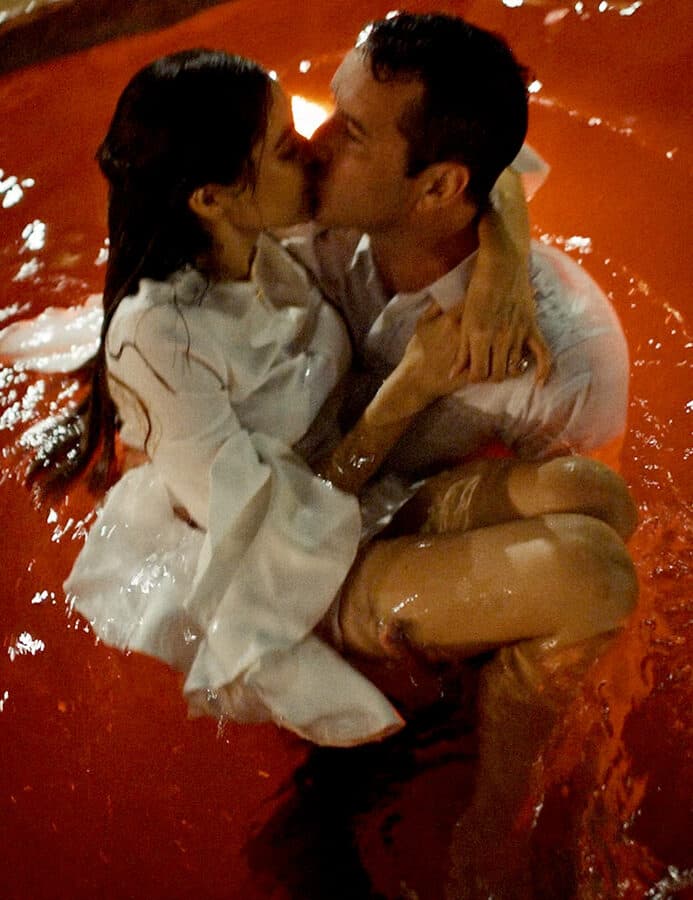 wedding couple kissing while in the pool at race and religious