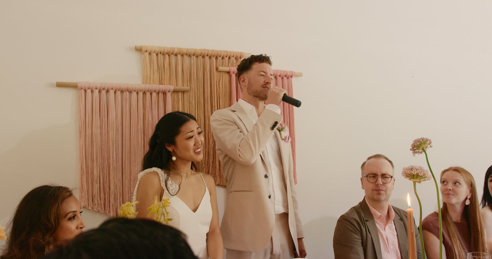 interracial couple making speech during dinner reception
