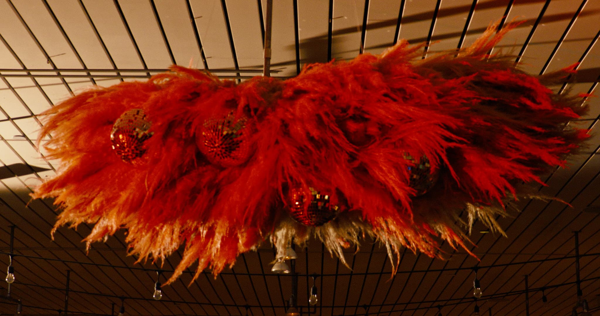 installation of pampas grace and disco balls hanging at ace hotel palm springs